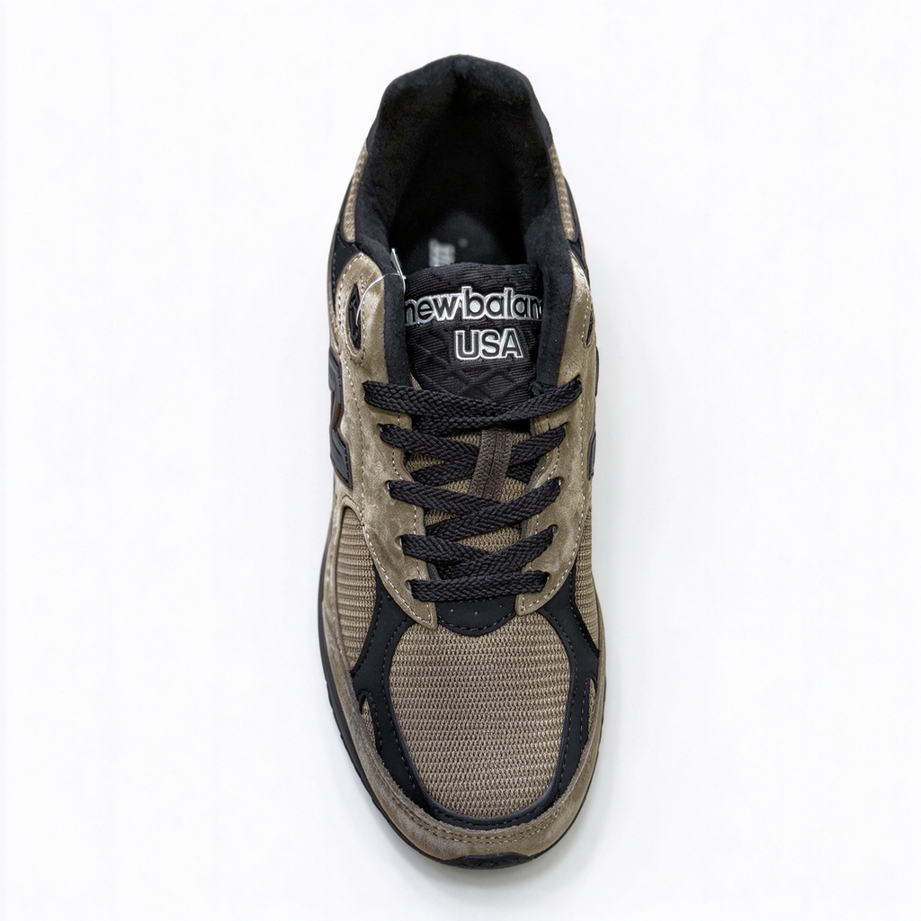 JJJJound x New Balance 990v3 classic collaboration model, Made in USA style. Premium brown suede matched with breathable mesh fabric, iconic dark black overlay, low-key vintage aesthetic, highly versatile for streetwear outfits.