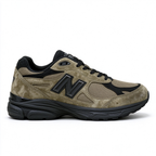 JJJJound x New Balance 990v3 classic collaboration model, Made in USA style. Premium brown suede matched with breathable mesh fabric, iconic dark black overlay, low-key vintage aesthetic, highly versatile for streetwear outfits.