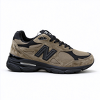 JJJJound x New Balance 990v3 classic collaboration model, Made in USA style. Premium brown suede matched with breathable mesh fabric, iconic dark black overlay, low-key vintage aesthetic, highly versatile for streetwear outfits.