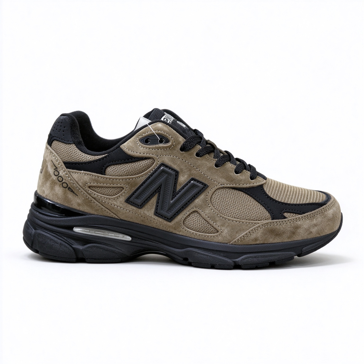 JJJJound x New Balance 990v3 classic collaboration model, Made in USA style. Premium brown suede matched with breathable mesh fabric, iconic dark black overlay, low-key vintage aesthetic, highly versatile for streetwear outfits.